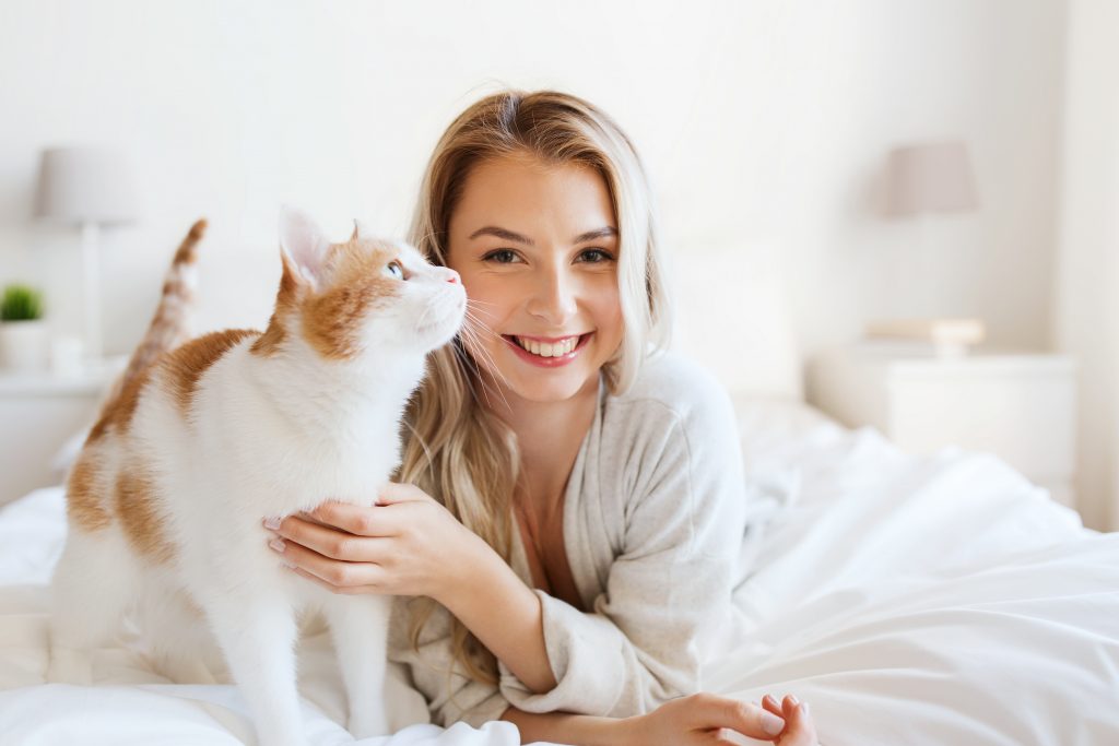 a happy first time home buyer with her pet cat